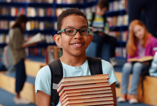 kid with stack of books